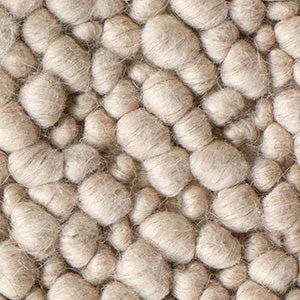 Close-up of a chunky natural wool rug