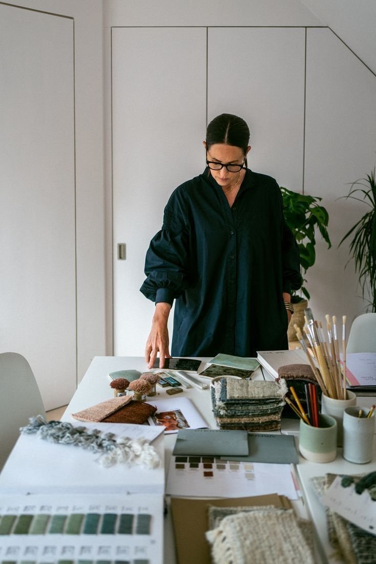 Interior designer reviewing material samples and colour swatches at a worktable
