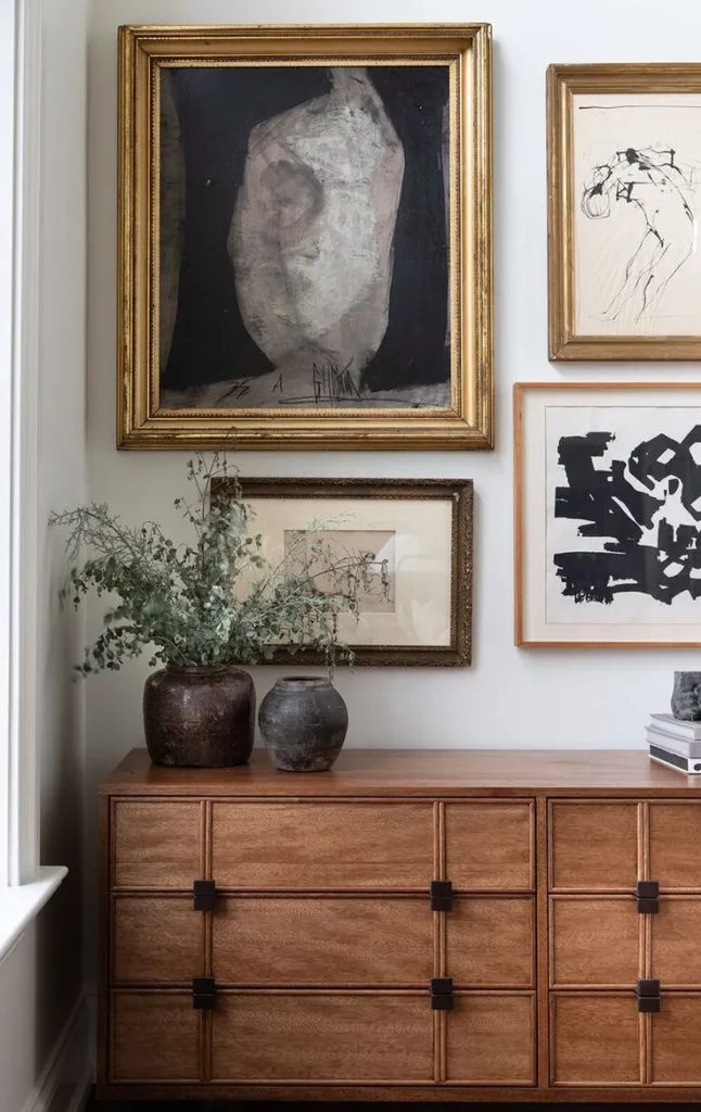 Dark marble coffee table styled with books, a candle and a tray beside a white sofa
