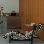 Le Corbusier LC4 chaise longue in cowhide against a warm wooden wall