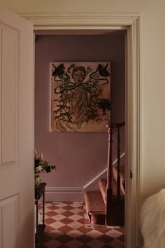 View through a doorway to a mauve hallway with the skirting painted to match the walls