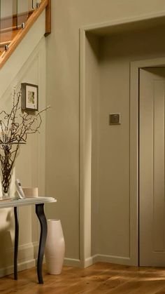 Hallway in soft grey-green with tonal skirting boards and doors painted in the same colour