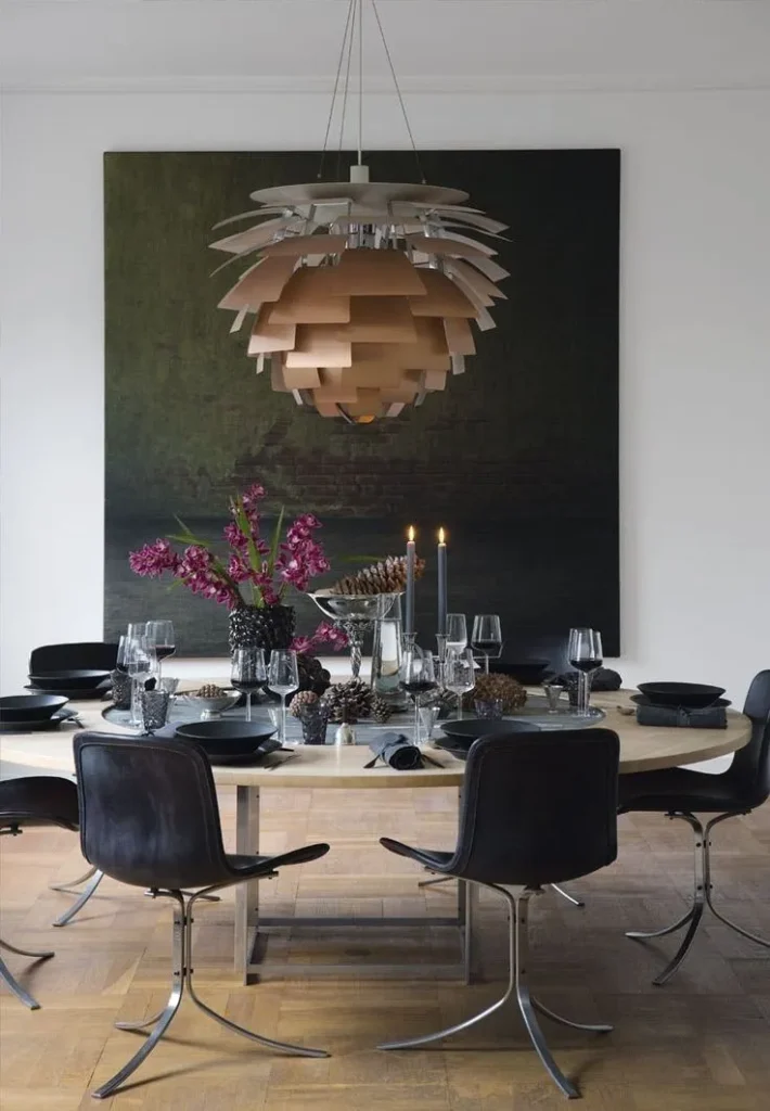 Poul Henningsen PH Artichoke pendant for Louis Poulsen above a dark dining table with leather chairs